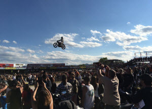 Crowd cheering motorcycle jumper